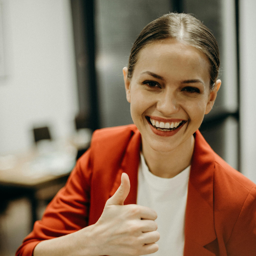 Image of smiling woman giving a thumbs-up